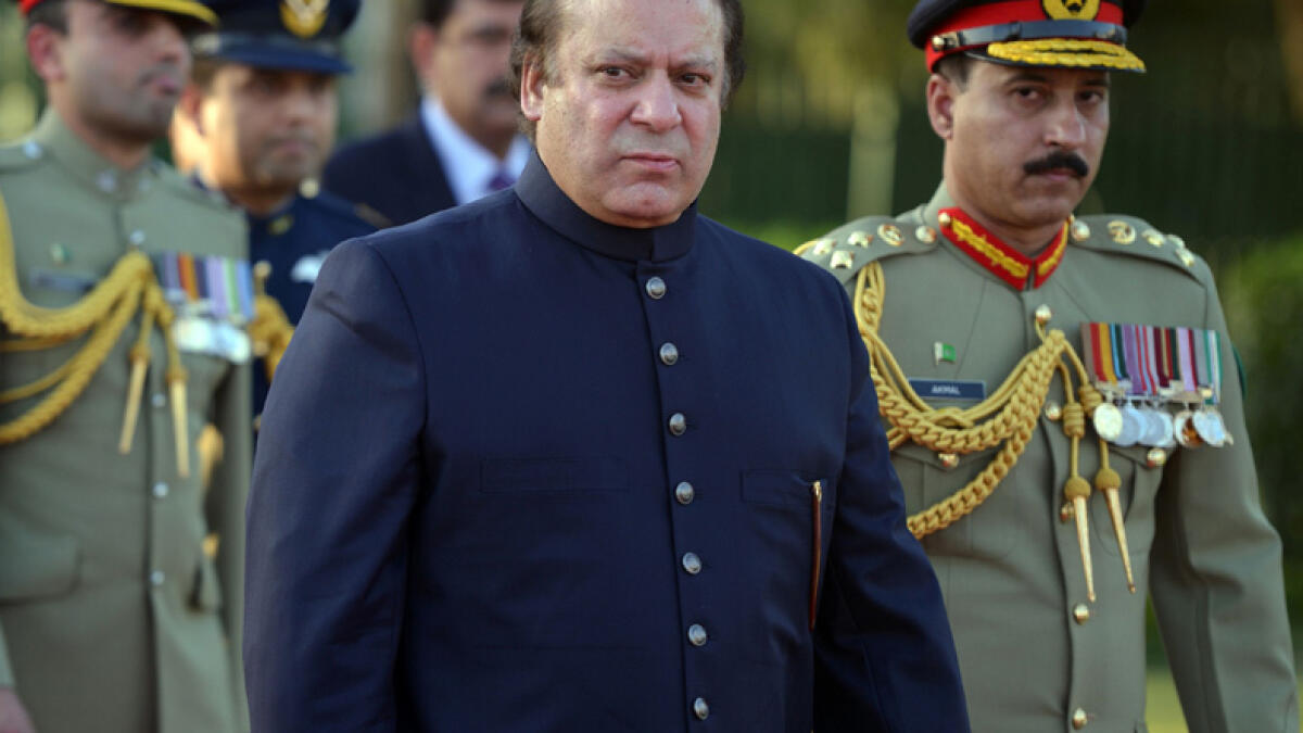 Nawaz Sharif listens to a reporter during a press conference 