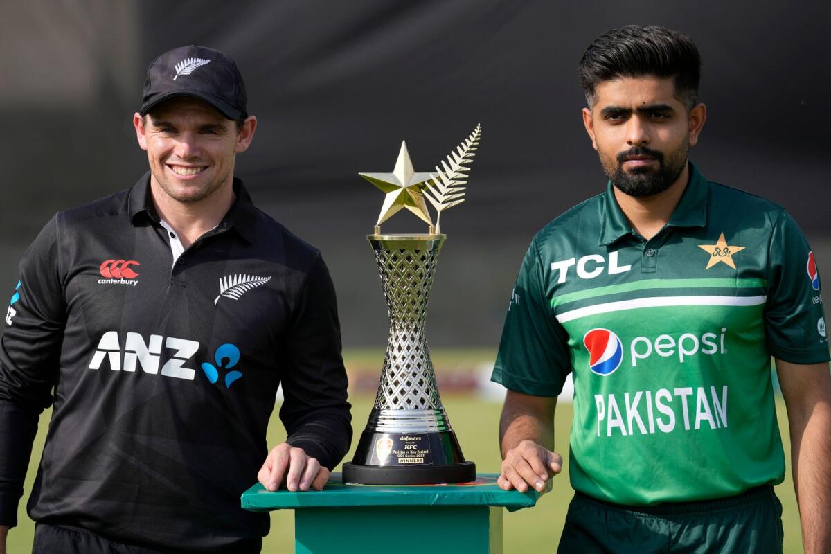 New Zealand's skipper Tom Latham (left) and his Pakistani counterpart Babar Azam pose with the trophy in Rawalpindi on Wednesday. — AP
