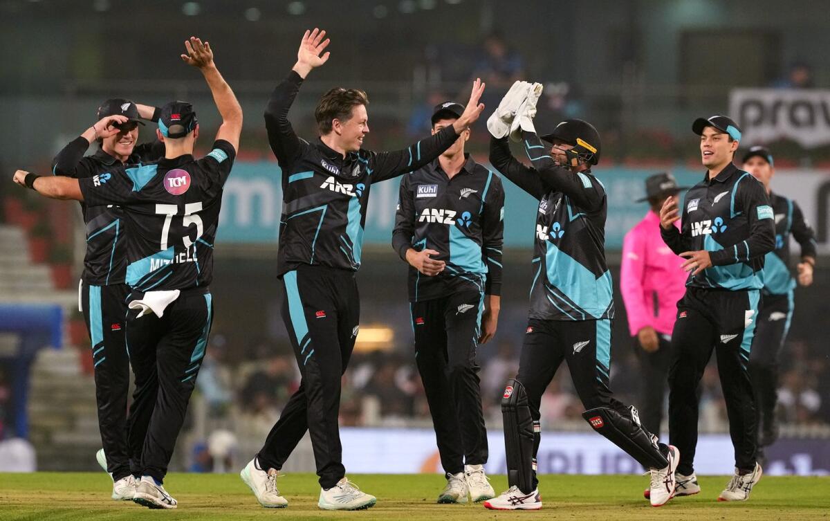 New Zealand bowler Michael Bracewell celebrates with teammates after the wicket of Indian batter Ishan Kishan. — PTI