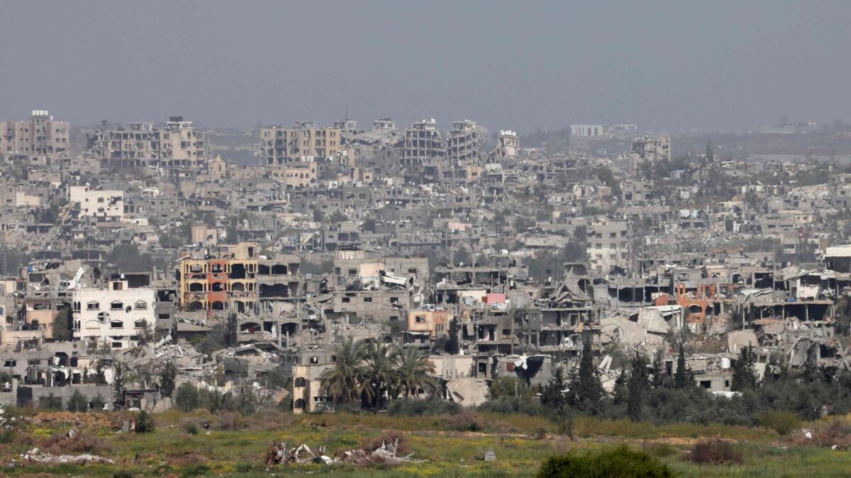 This picture taken from Israel's southern border with the Gaza Strip shows buildings which have been destroyed by Israeli strikes. — AFP