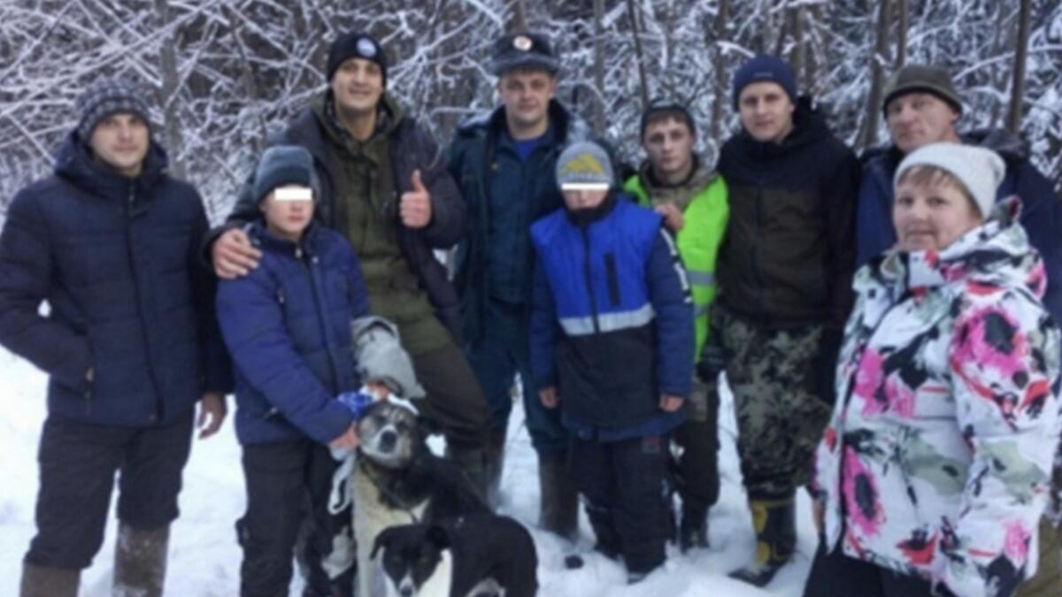 Two boys cuddle dogs to survive harsh winter in forest 