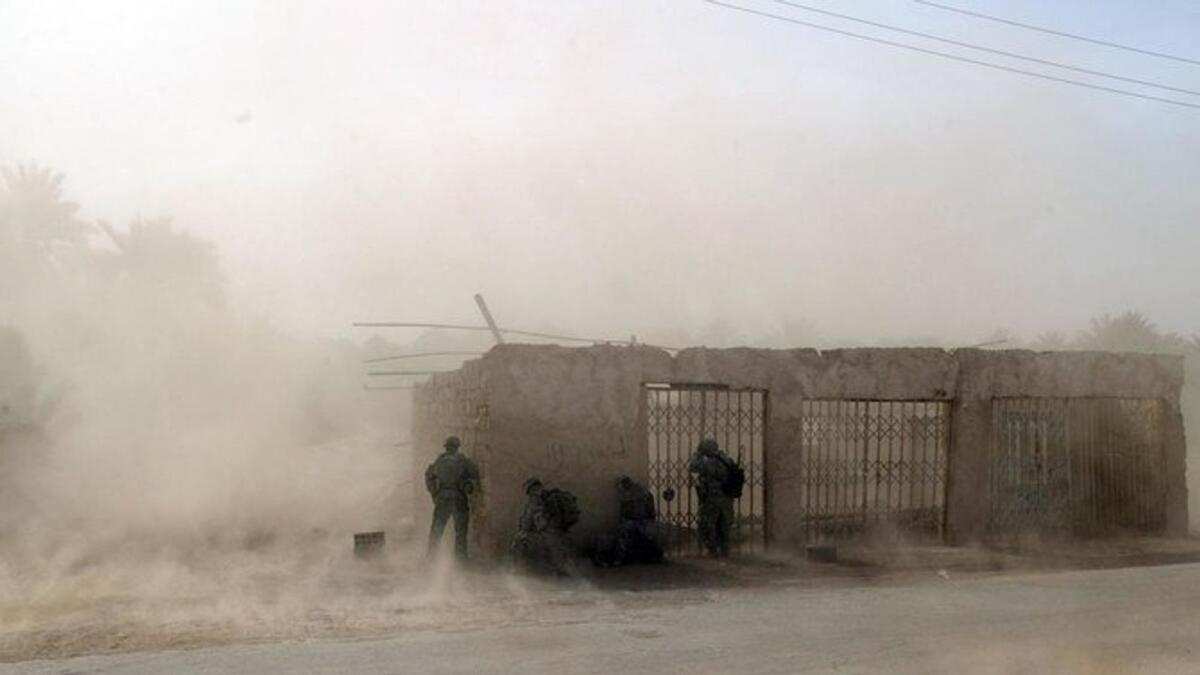 In this file photo US soldiers take cover as US Blackhawk helicopters drop troops at a US army military base in Salman Pak, south of Baghdad, on April 15, 2008.