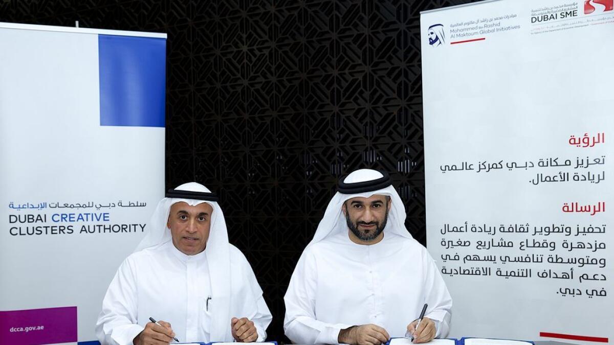 Ahmad bin Bayat, director general of DCCA, and Abdul Baset Al Janahi, CEO of Dubai SME at the signing  ceremony. 
