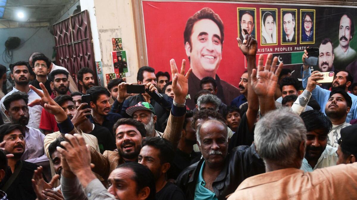 Pakistan Peoples Party (PPP) supporters celebrate the victory of a provincial assembly candidate in Karachi. — AFP