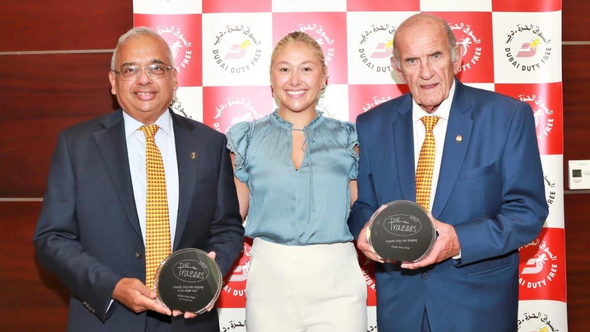 Dubai Duty Free Executive Vice Chairman and CEO Colm McLoughlin (right) and Chief Operating Officer Ramesh Cidambi accept the Trazees Awards trophies from Global Traveller and Trazees Travel Advertising Manager Haley Fogarty. - Supplied photo