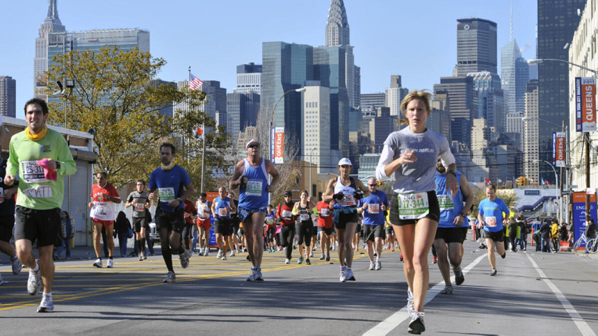 Runners make their way down 44th Drive in the Queens borough of New York during the 2011 New York City Marathon. -- AFP file