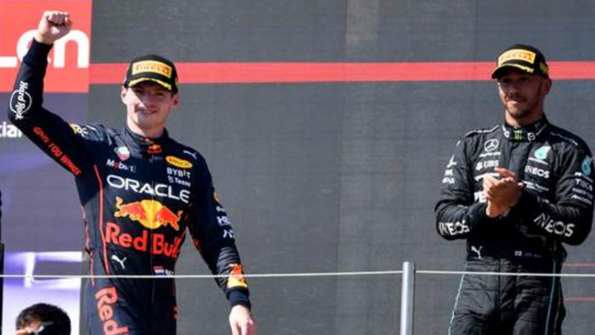 Max Verstappen (left) celebrates on the podium. — AFP