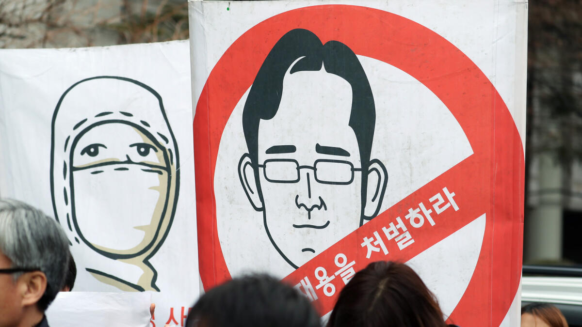 A placard with a cartoon in the likeness of Jay Y. Lee is seen during a protest outside the Seoul Central District Court. — Bloomberg
