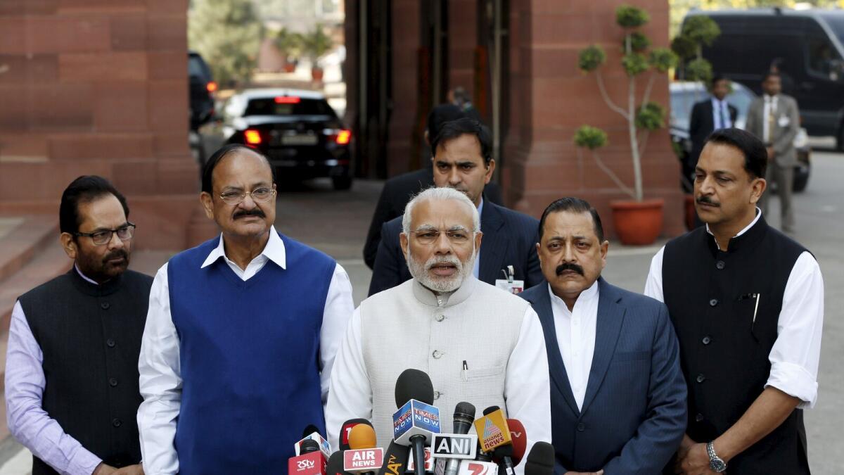 Indian Prime Minister Narendra Modi (C) speaks with the media inside the parliament premises upon his arrival on the first day of the budget session in New Delhi, India, February 23, 2016.