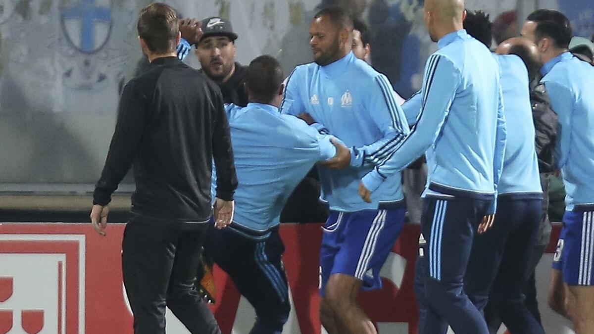 Evra fired by Marseille, banned by UEFA for kicking fan