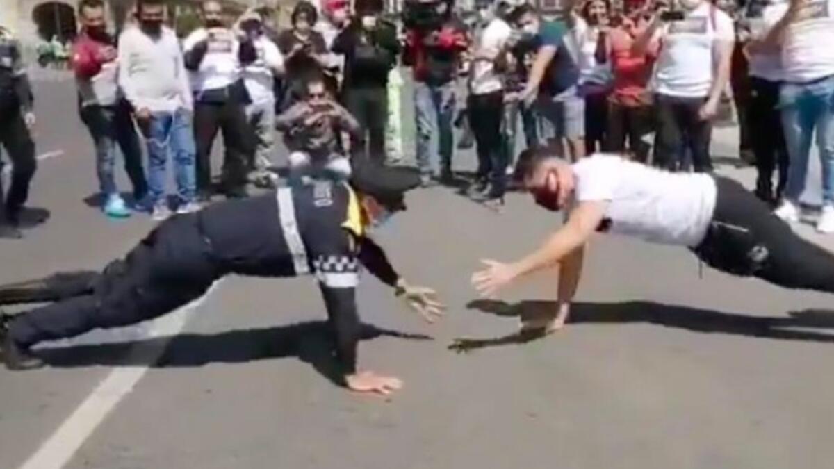 Policeman, protester, push-up challenge