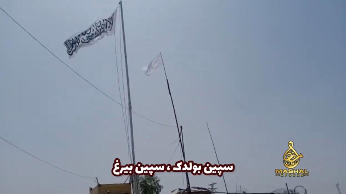 An Islamic Emirate of Afghanistan flag flutters in front of the friendship gate of Afghanistan and Pakistan at the Wesh-Chaman border crossing, Spin Boldak, Afghanistan, on July 14, 2021.