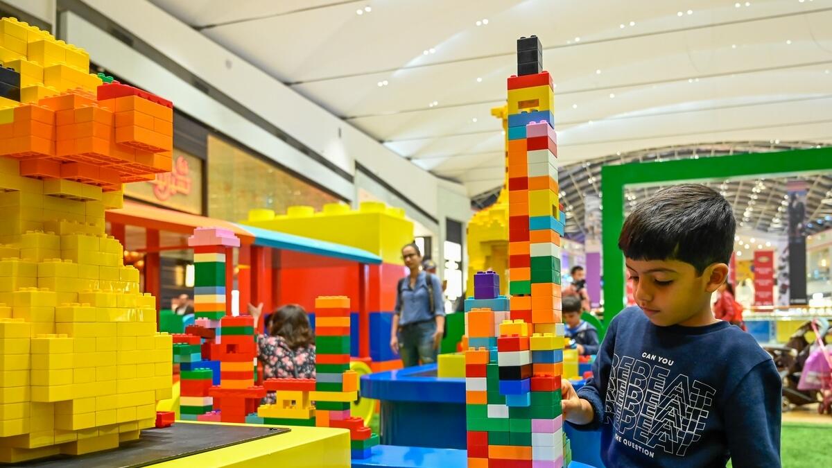 A child puts together a Lego structure.
