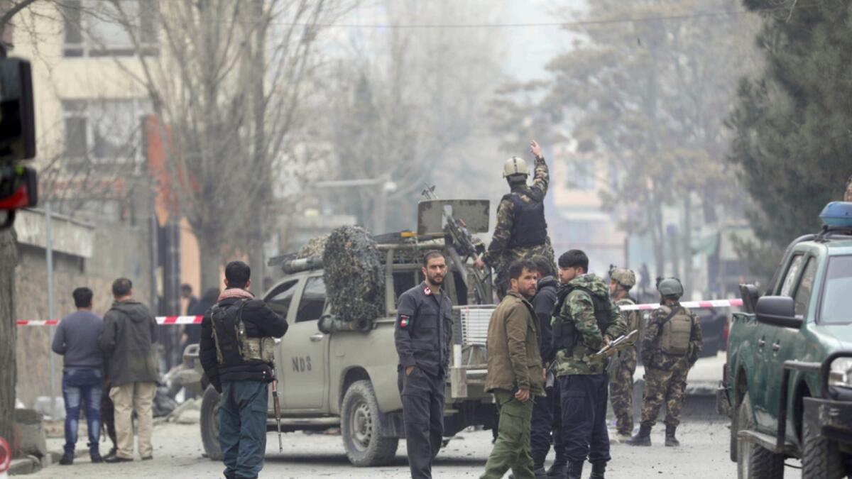 Security personnel inspect the site of a bomb attack in Kabul in February. — AP