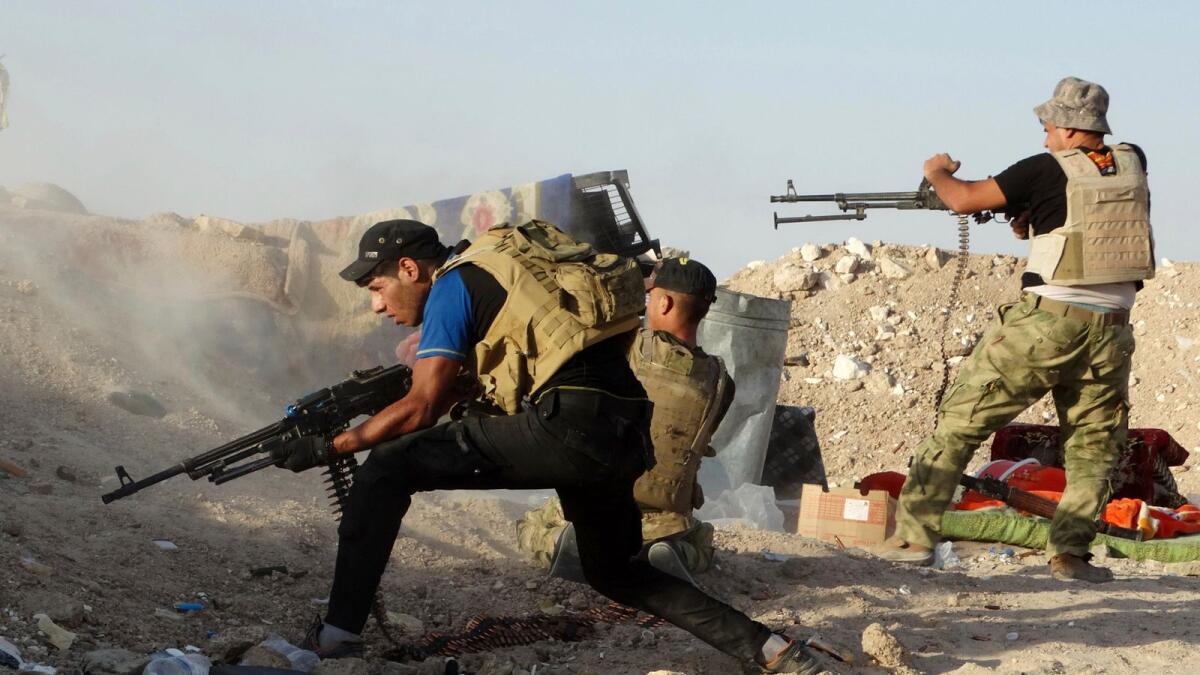 Iraqi security forces defend their positions against a Daesh attack in Husaybah, east of Ramadi, Iraq, on June 15, 2015. — AP file