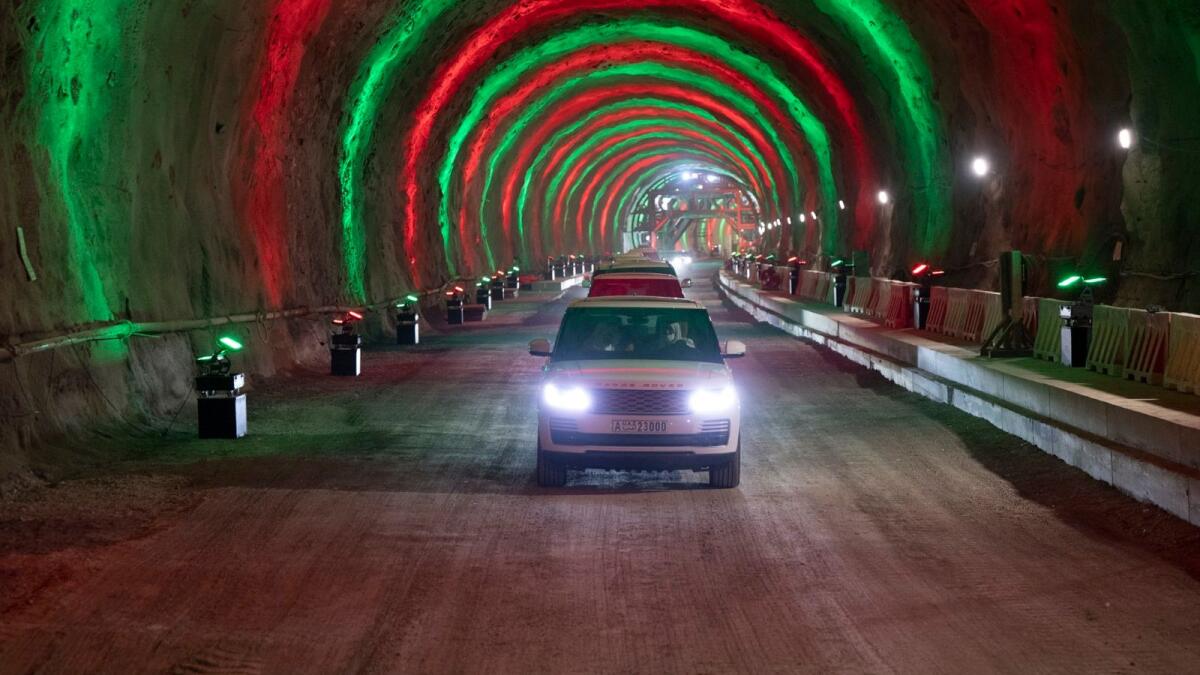 Officials drive through a new tunnel completed as part of the Etihad Rail project in Fujairah. — Wam