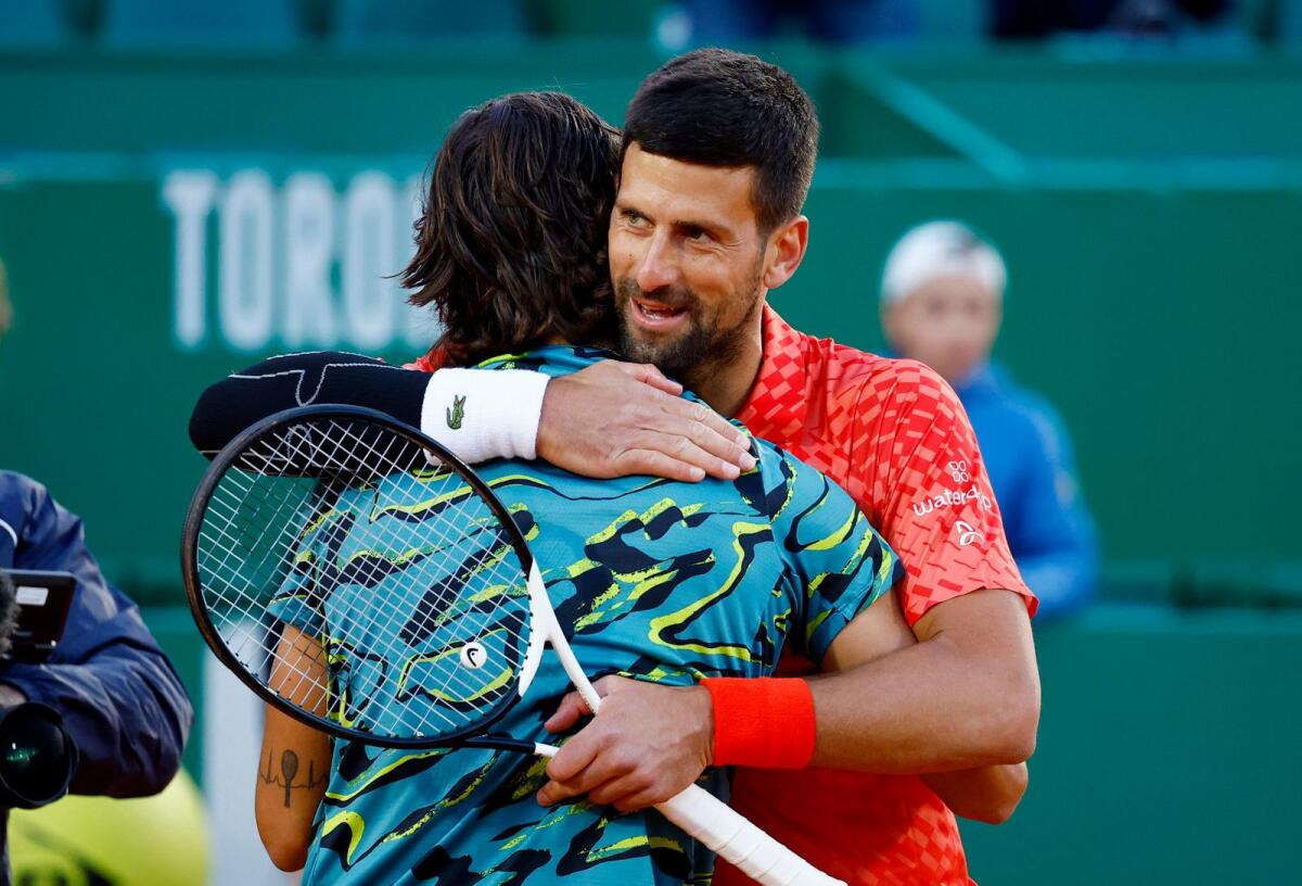 Novak Djokovic congratulates Lorenzo Musetti after their round of 16 match. —  Reuters