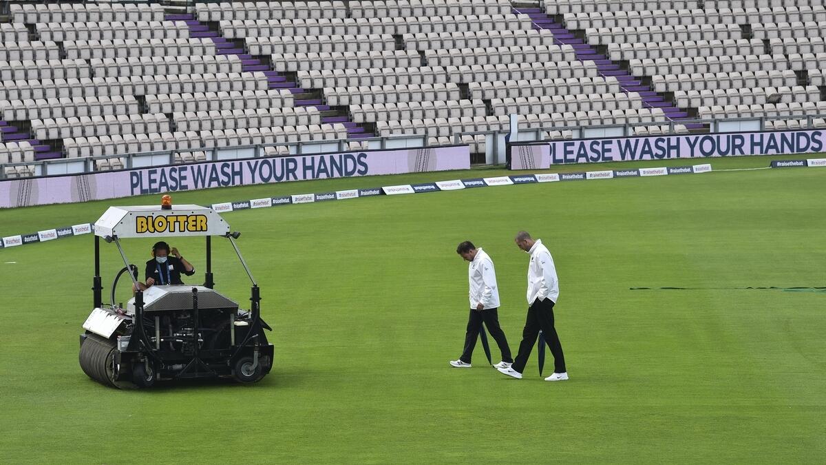 Umpires Richard Kettleborough and Michael Gough return after inspecting the pitch area as rain delayed start the fifth day of the second cricket Test match between England and Pakistan in Southampton