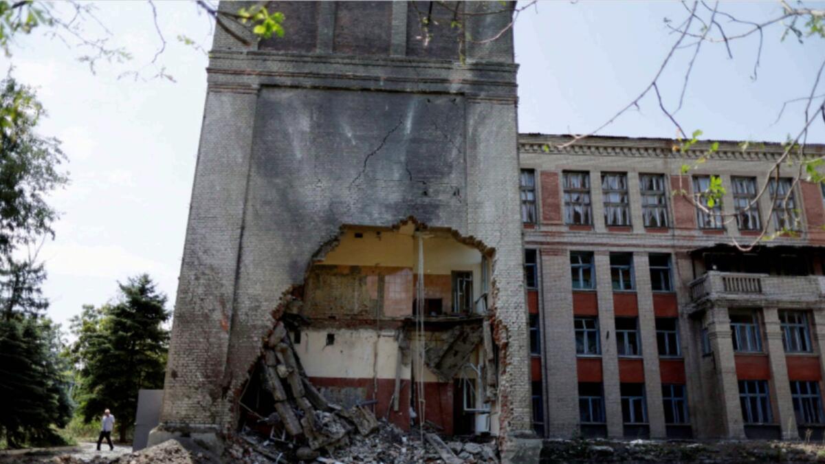 A man walks near a destroyed school in Kostyantynivka, Donetsk region. — Reuters