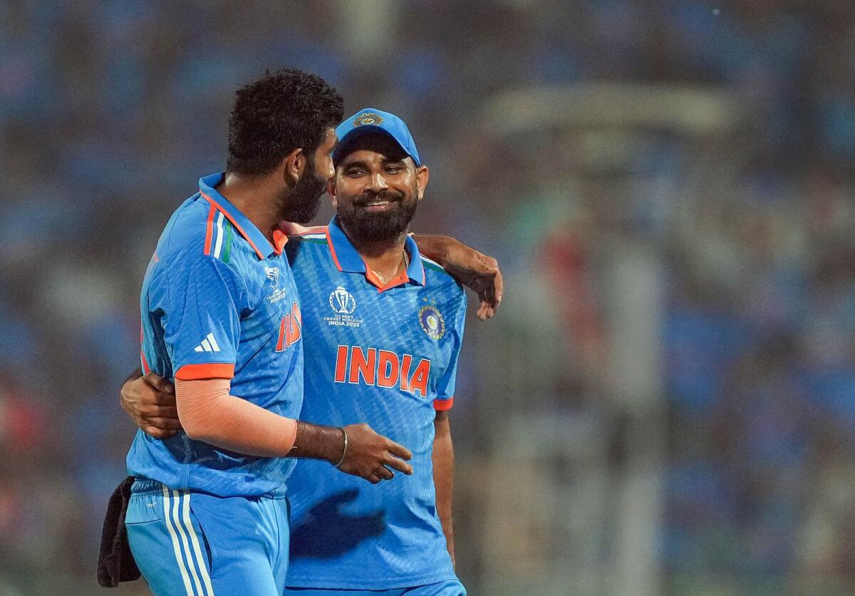 India's Jasprit Bumrah and Mohammed Shami celebrate after winning the ICC Men's Cricket World Cup 2023 match against England. Photo: PTI