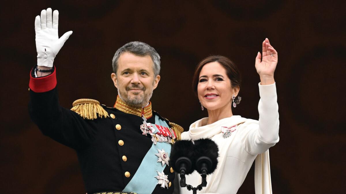 King Frederik X of Denmark and Queen Mary of Denmark wave to the crowd from the balcony of Christiansborg Palace in Copenhagen, Denmark.
