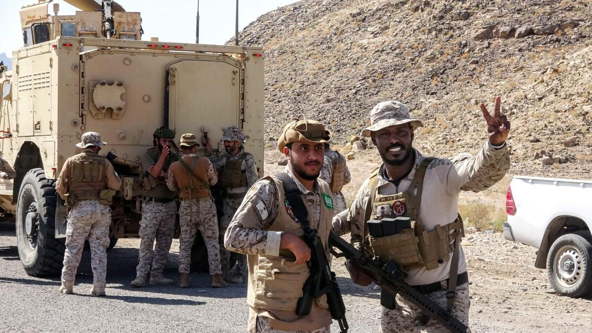 Saudi soldiers pose for a picture during the withdrawal of fighters loyal to Yemen's separatist Southern Transitional Council (STC) in Yemen's southern Abyan province.