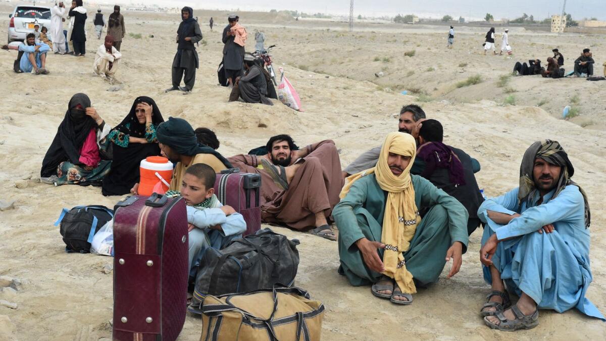 People wait for the opening of border crossing in the Pakistan's border town of Chaman, following clashes between Afghan forces and Taleban fighters. Photo: AFP