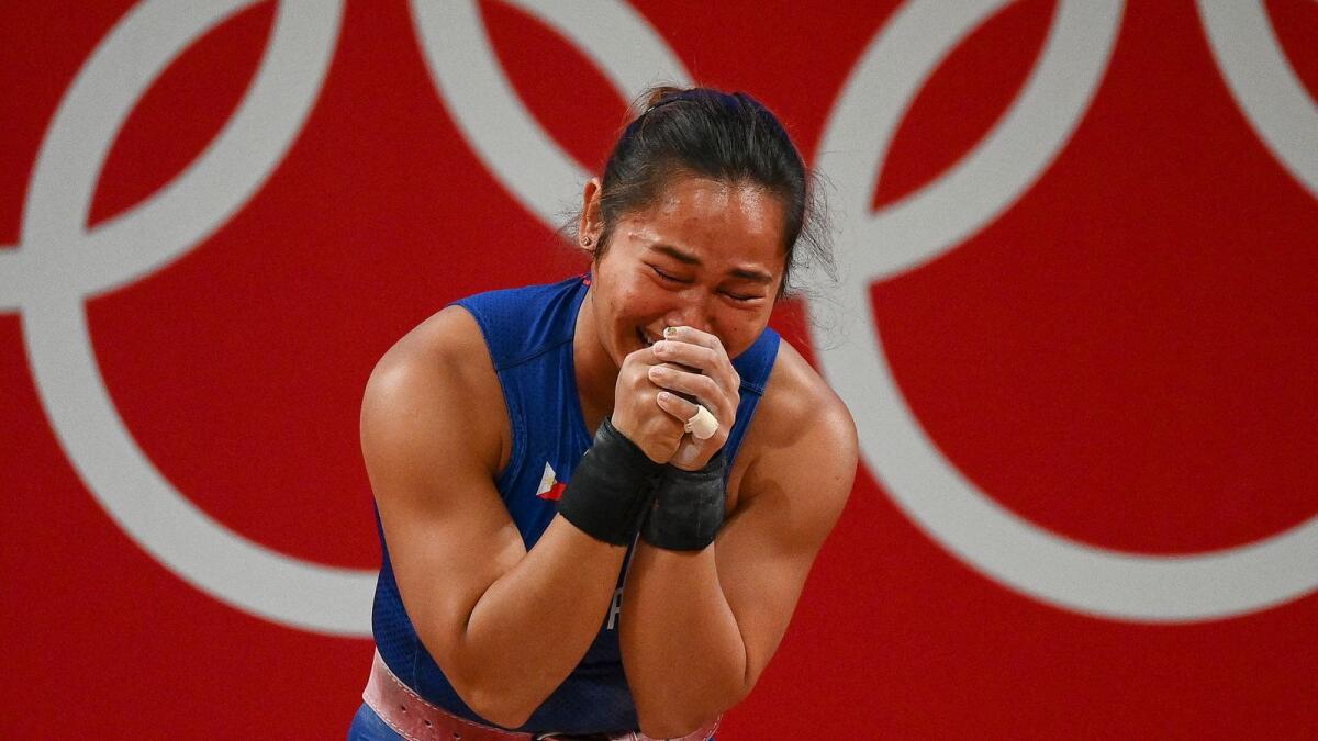 Philippines' Hidilyn Diaz reacts after winning the gold medal in the women's 55kg weightlifting competition at the Tokyo Olympics. (AFP)