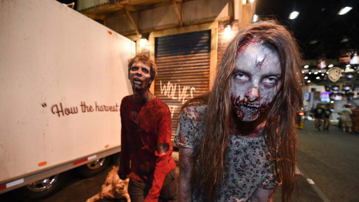 Zombies practices their walk at AMC's 'Walking Dead' booth