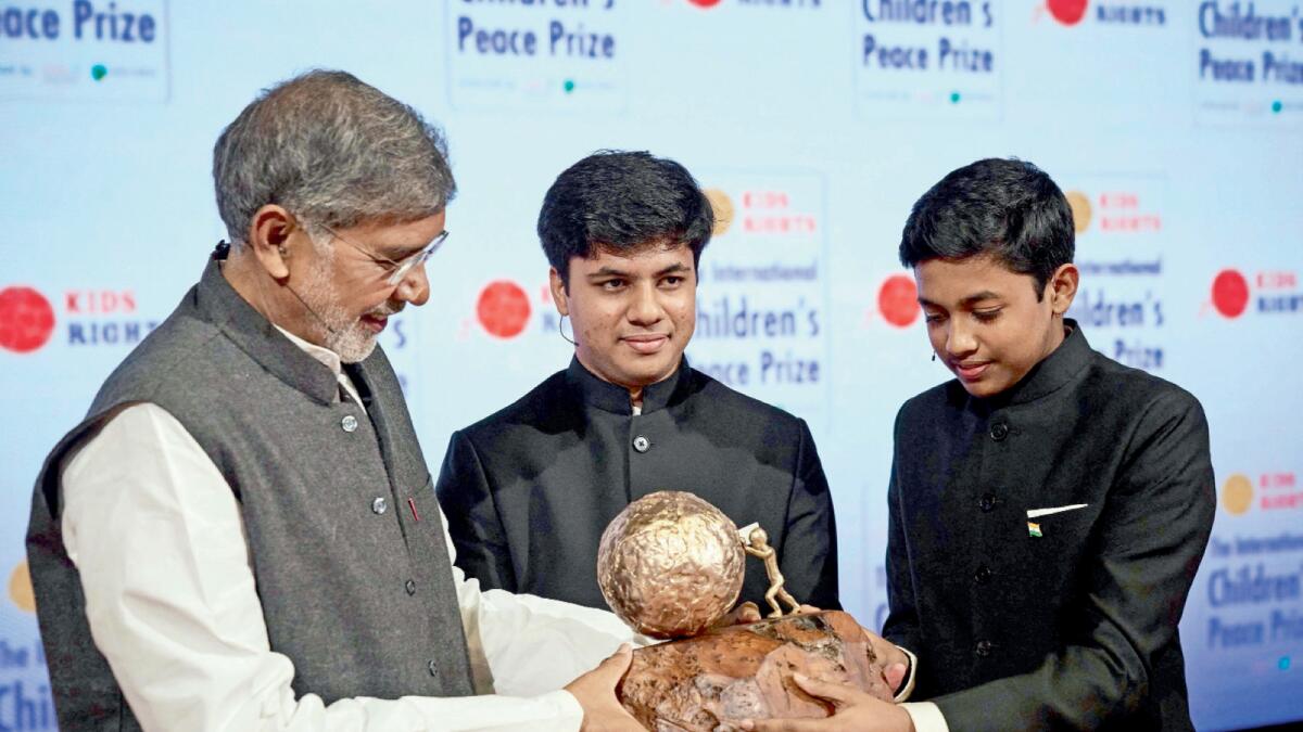 Nobel Peace Prize winner 2014 Kailash Satyarthi (left) presents the International Children's Peace Prize 2021 to Vihaan and Nav Agarwal from India in The Hague, on November 13. –AFP