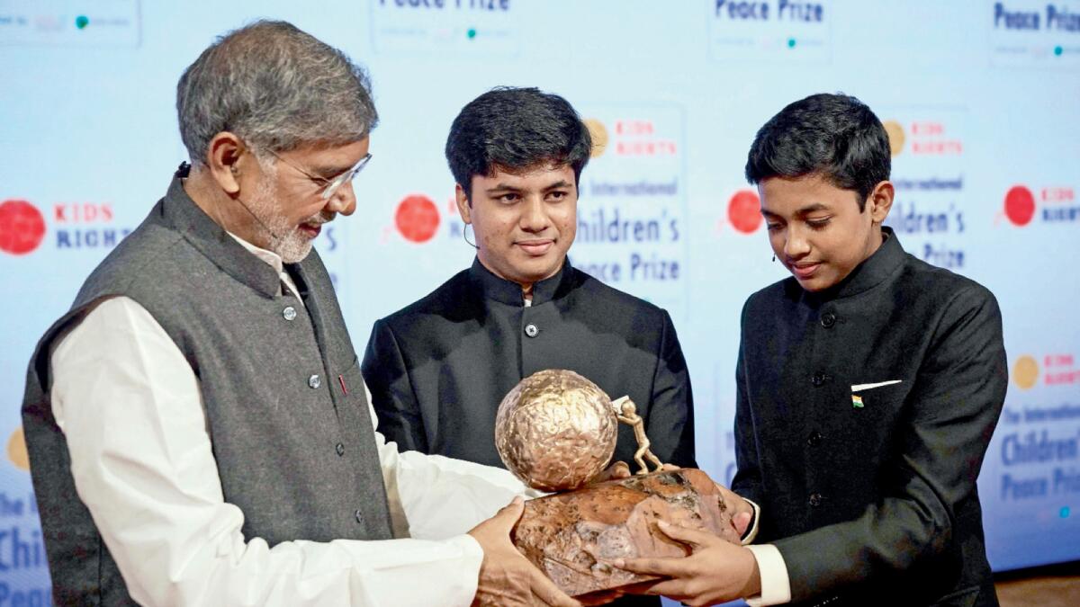 Nobel Peace Prize winner 2014 Kailash Satyarthi (left) presents the International Children's Peace Prize 2021 to Vihaan and Nav Agarwal from India in The Hague, on November 13. –AFP