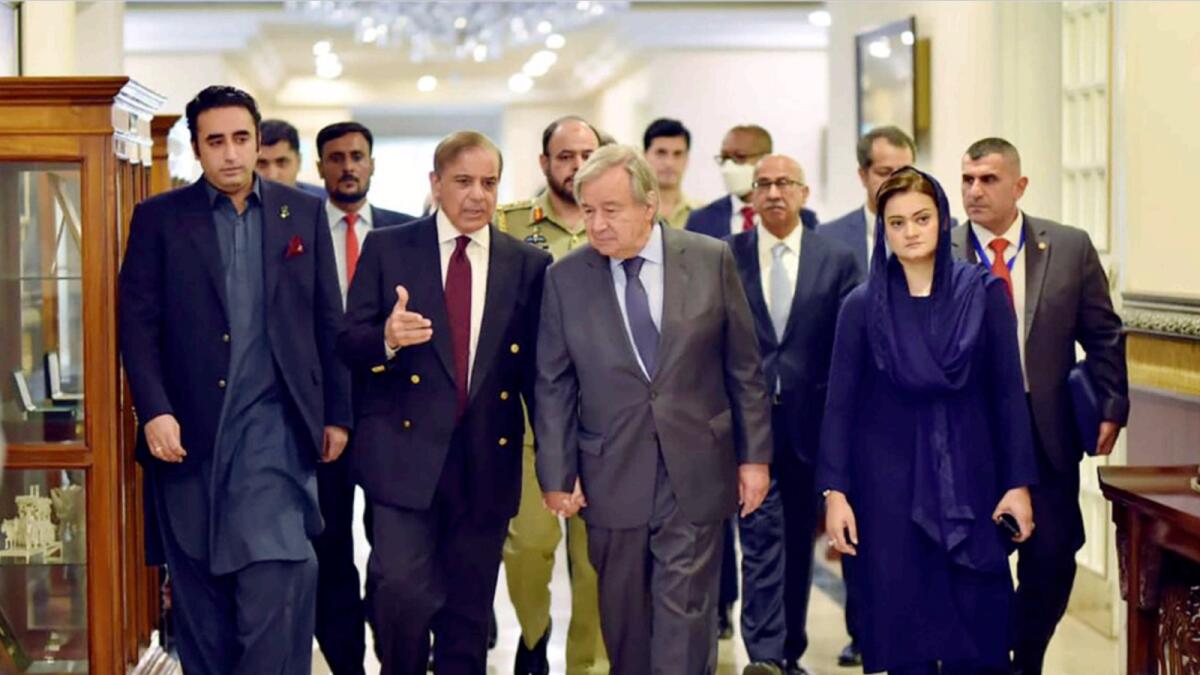 UN Secretary-General Antonio Guterres walks with Pakistani Prime Minister Shahbaz Sharif and other officials in Islamabad. — AP