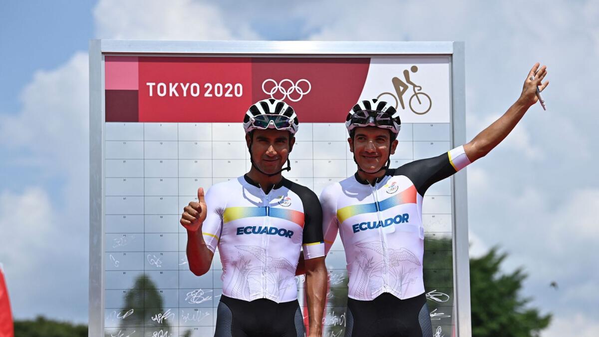 Ecuador's Richard Carapaz (right) and Jhonatan Manuel Narvaez Prado pose for a picture before the start of the men's cycling road race. — AFP