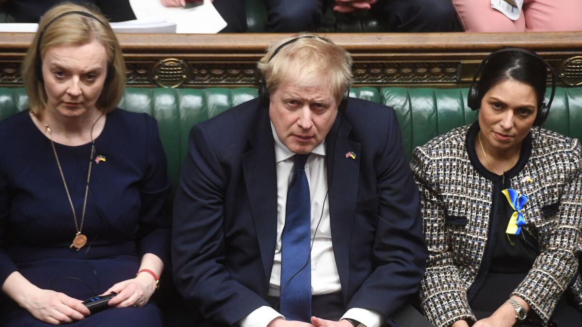 (From L-R) Britain's Foreign Secretary Liz Truss, Britain's Prime Minister Boris Johnson and Britain's Home Secretary Priti Patel listening to Ukraine's President Volodymyr Zelensky speaking to them by live video-link in the House of Commons, in London, on March 8, 2022. (AFP)