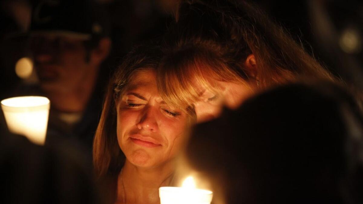 People take part in candle light vigil following a mass shooting at Umpqua Community College in Roseburg, Oregon.