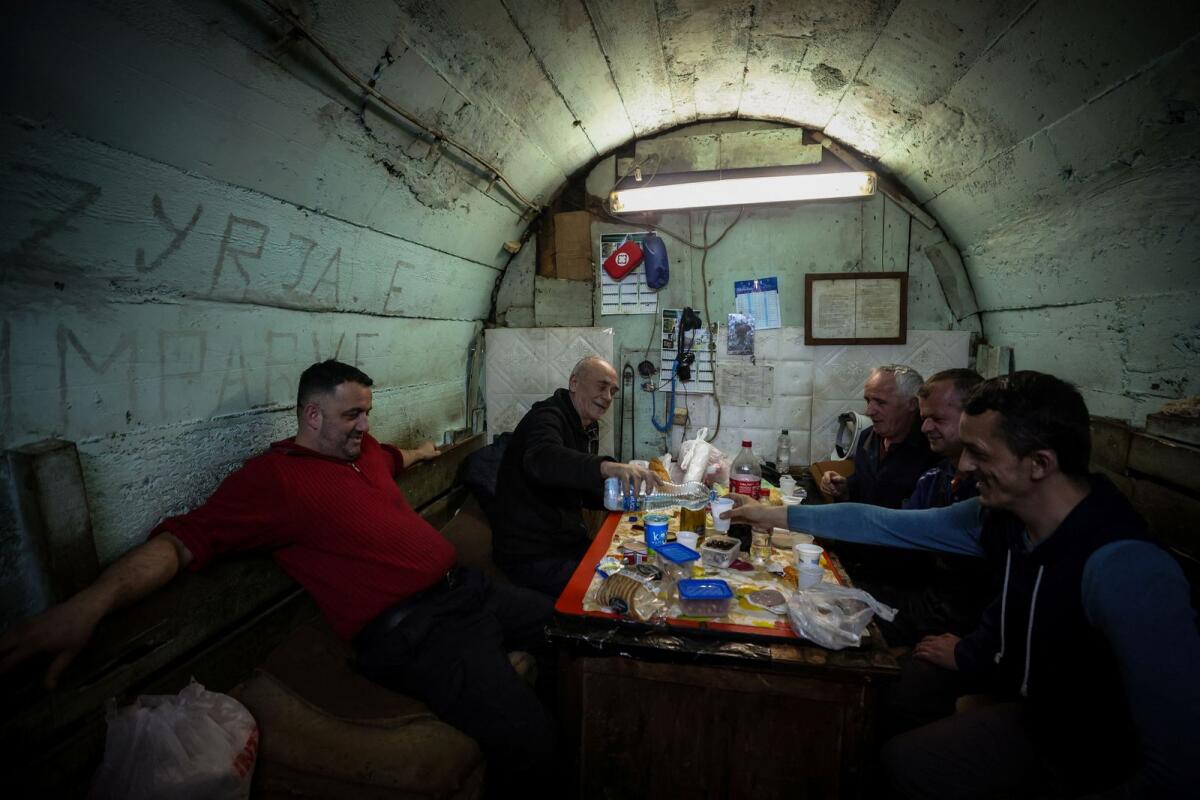 Miner Emin Hasani and his colleagues end their fast during the holy month of Ramadan in a makeshift office 800 metres underground where miners eat at Trepca Mine in Stanterg, near Mitrovica, Kosovo, on March 14. — Reuters