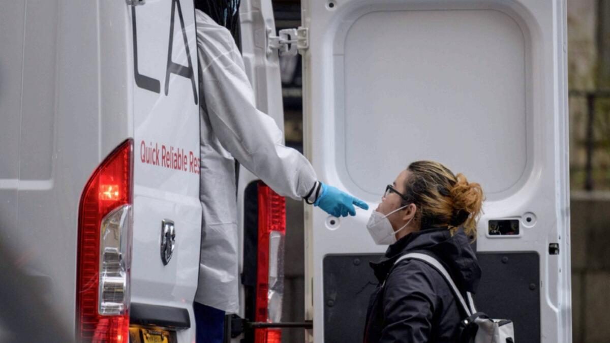 A person receives a Covid-19 test out of a mobile testing van in New York City. — AFP