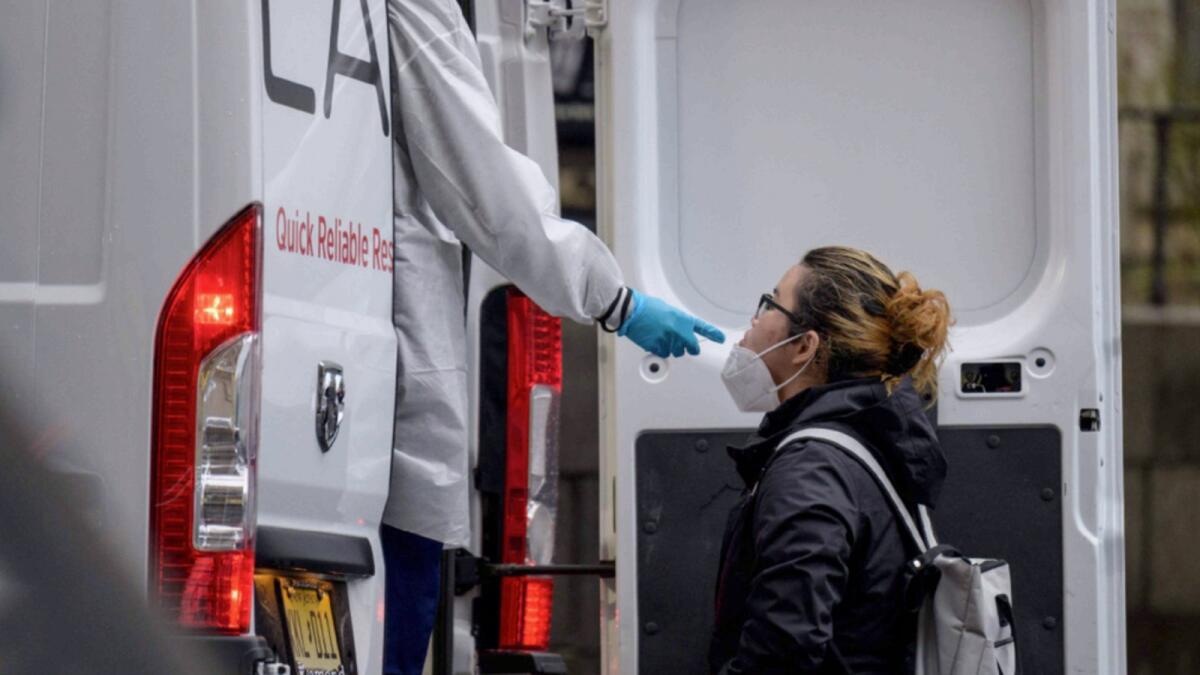 A person receives a Covid-19 test out of a mobile testing van in New York City. — AFP