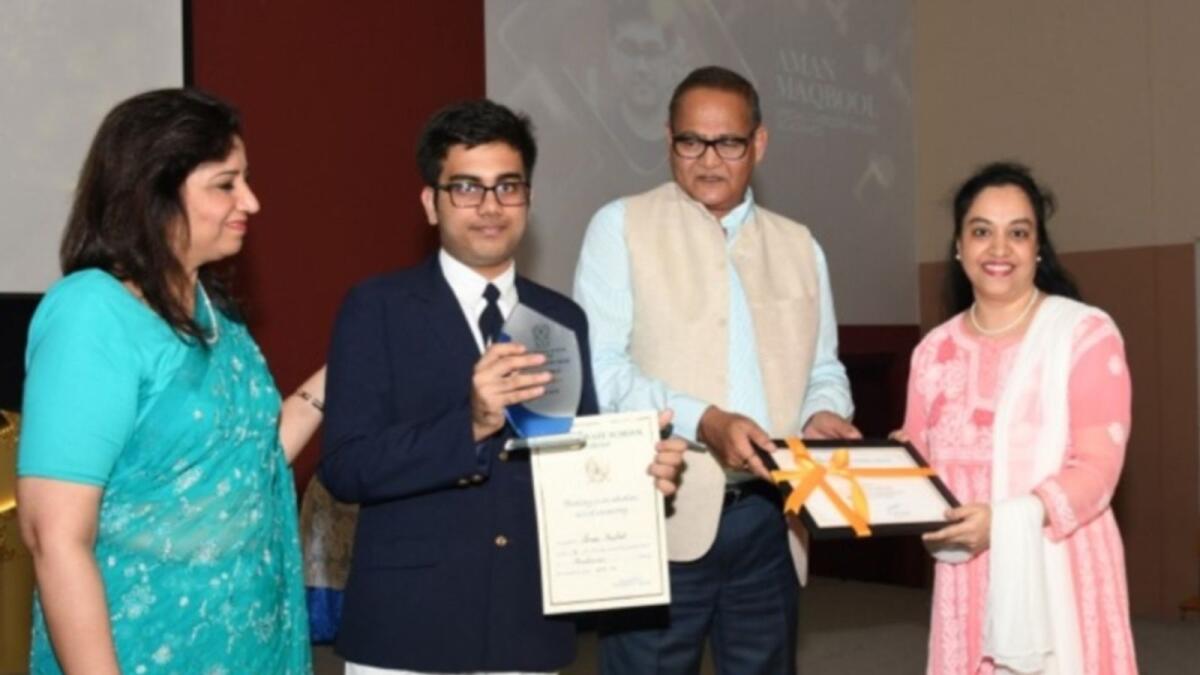 Aman receives an award.