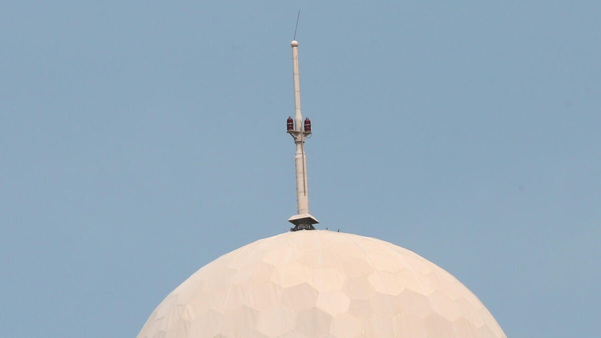 The 'golf ball' atop the etisalat headquarters in Abu Dhabi is in the process of being dismantled and 100 metres perimetre around the building has been closed to all traffic. -Photo By Ryan Lim