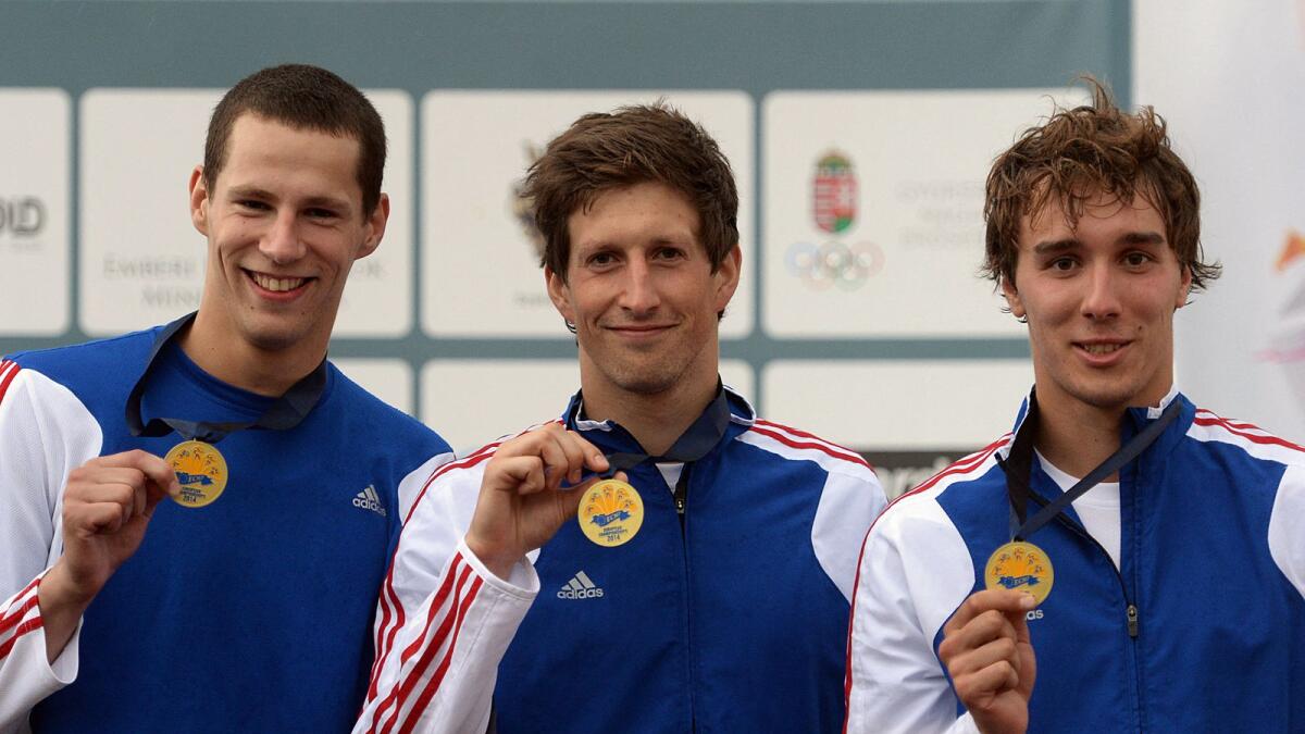 Czech Republic's Ondrej Polivka (left), Martin Bilkos (centre) and Jan Kuf celebrate on the podium with their bronze medals at the 2014 Modern Pentathlon European Championships. (AFP file)