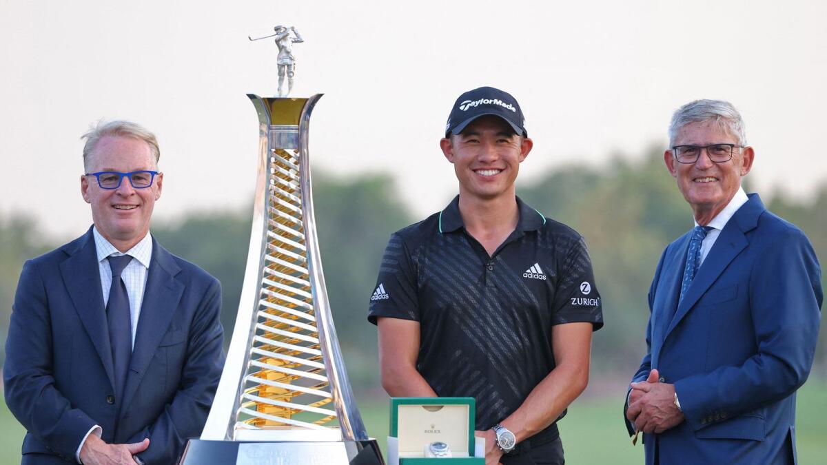Collin Morikawa of the US poses with the winner's trophy during the awards ceremony in Dubai. (AFP)