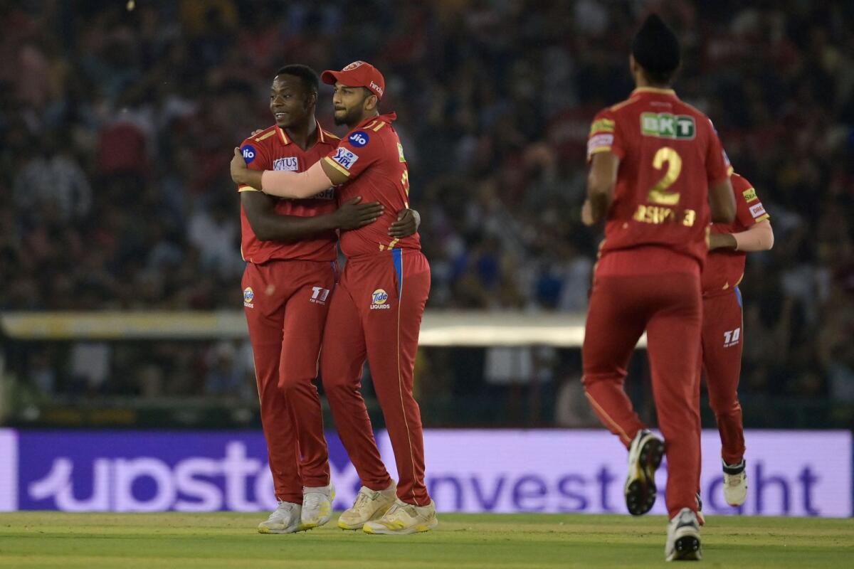 Punjab Kings' Kagiso Rabada (left) celebrates after taking the wicket of Gujarat Titans' Wriddhiman Saha (not pictured). — AFP