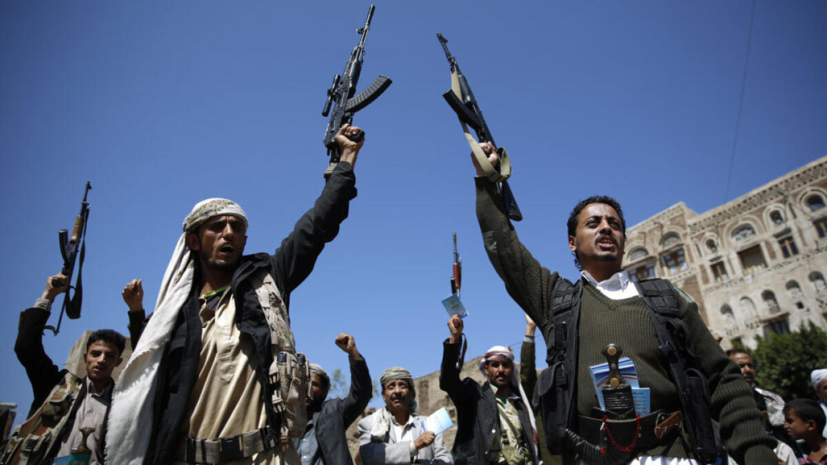 Houthi militants holding their weapons chant slogans during a tribal gathering. — File photo