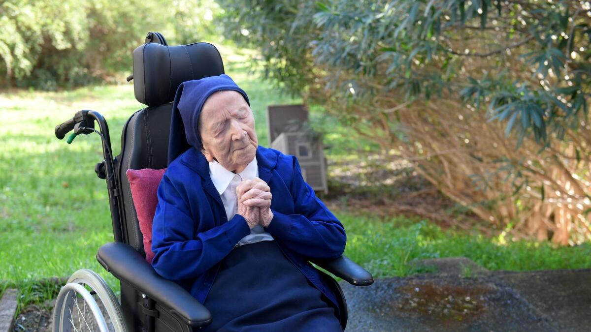 In this file photo taken on February 10, 2021, Lucile Randon, the eldest French and European citizen, prays in a wheelchair on the eve of her 117th birthday in Toulon, France.  The world's oldest known person, Lucile Randon has died aged 118, her spokesman said on January 17, 2023. — AFP