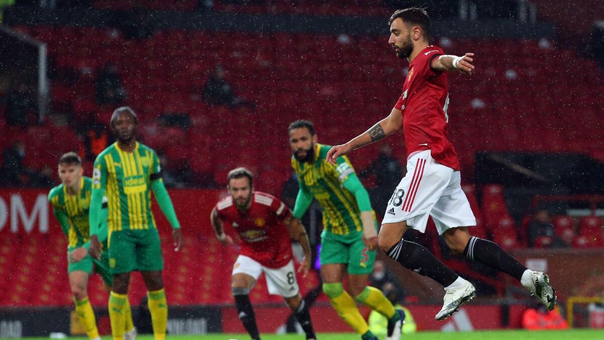 Manchester United's Portuguese midfielder Bruno Fernandes scores from a penalty during the English Premier League  against West Bromwich Albion.— AFP