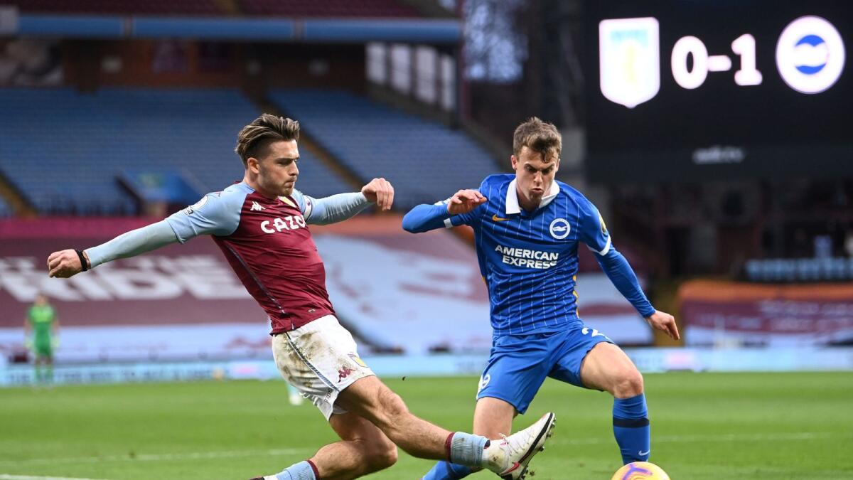 Aston Villa's English midfielder Jack Grealish (left) fights for the ball with Brighton's English midfielder Solly March. — AFP