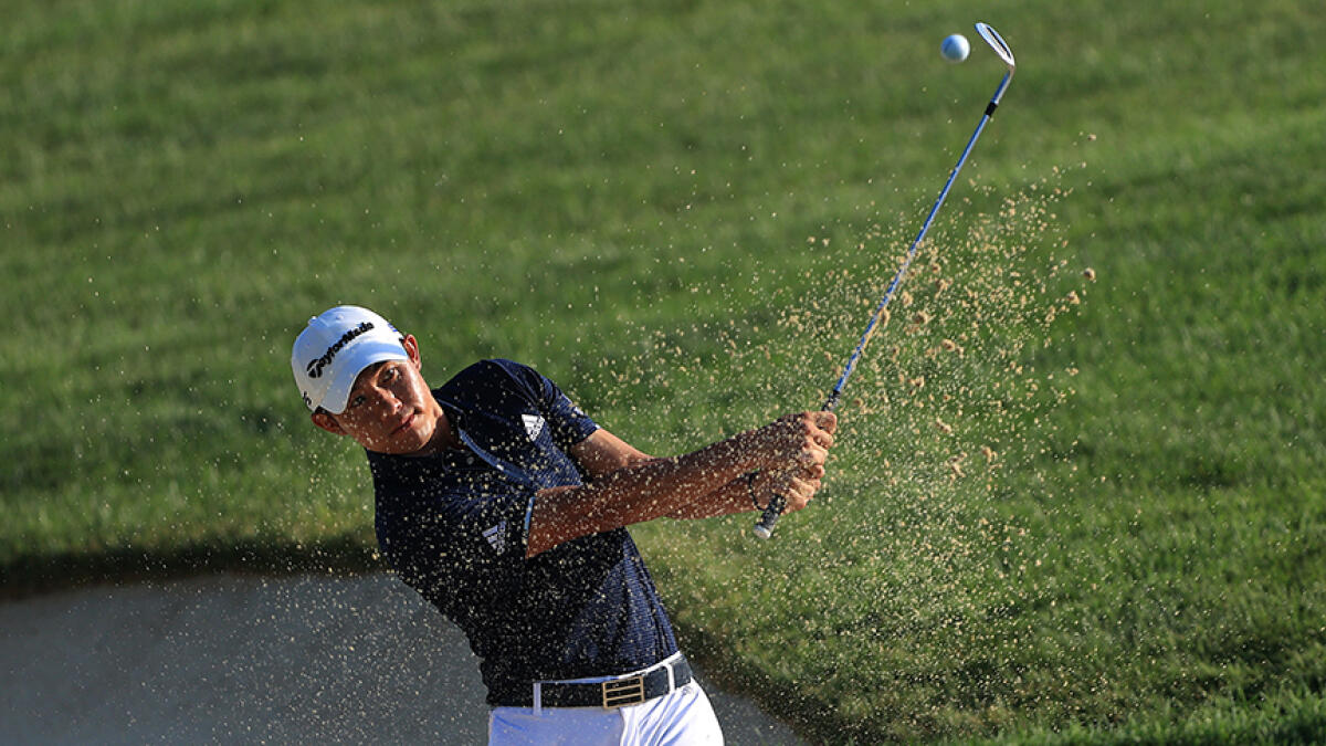 Collin Morikawa hits a shot from the sand on the 14th hole during the second round of the Workday Charity Open at Muirfield Village Golf Club in Dublin, Ohio.  -- AFP