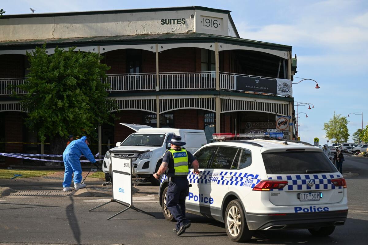 Victorian police work the scene of a deadly car crash outside the Royal Hotel in Daylesford, Australia, on Monday. — AP