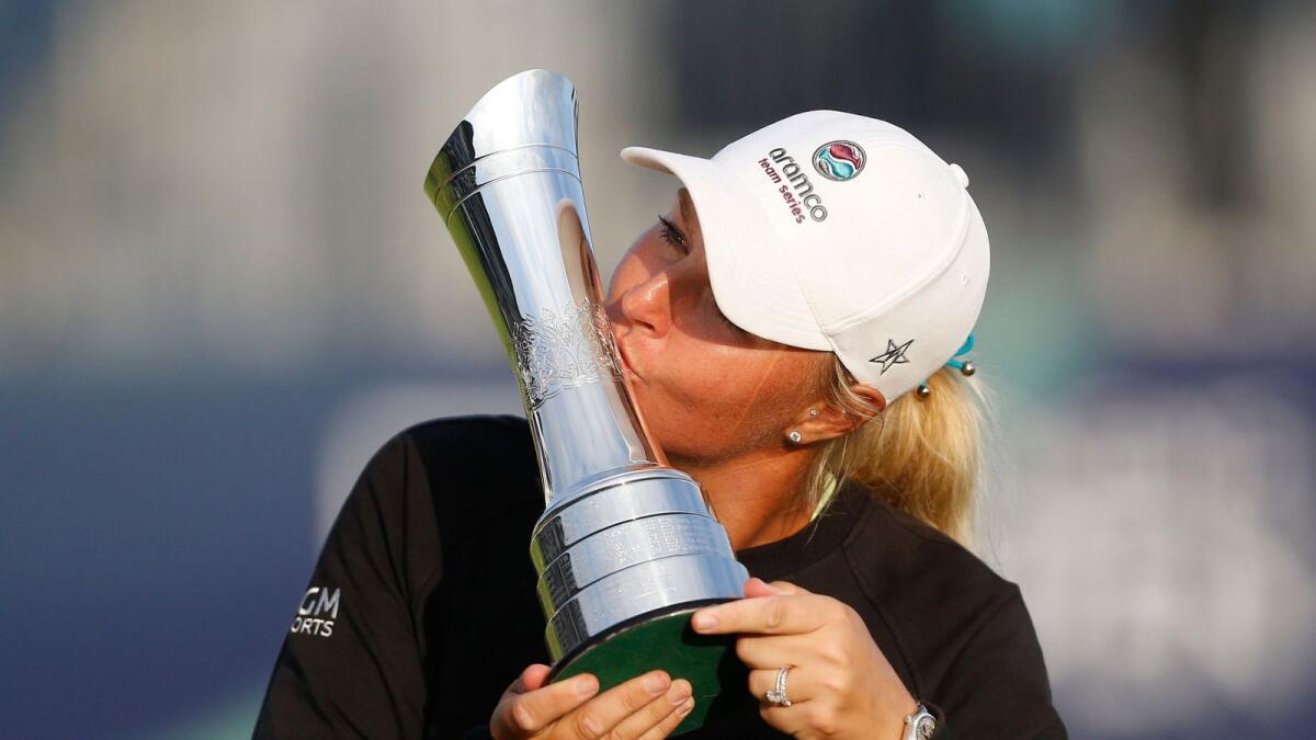 Sweden's Anna Nordqvist kisses her trophy and celebrates after winning the Open. — Reuters